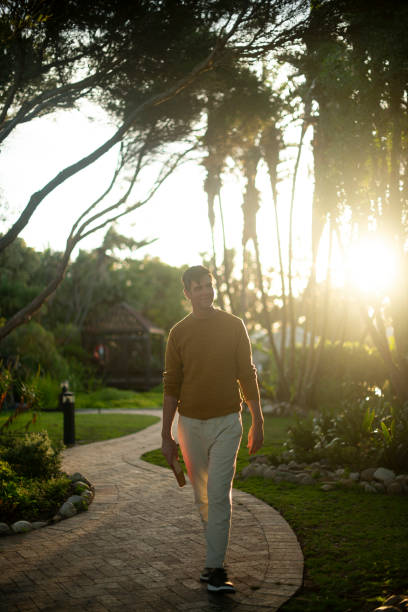 istock Relax, thinking and path with man in park for adventure, reflection and environment. Resting, sunset and wellness with mature person in nature reserve for calm, summer vacation and inspiration 2200365252