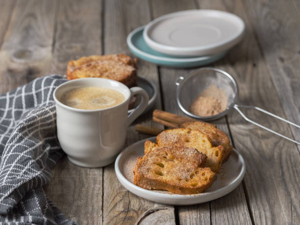 Coffee with milk accompanied by delicious homemade torrijas with sugar and cinnamon. rustic atmosphere