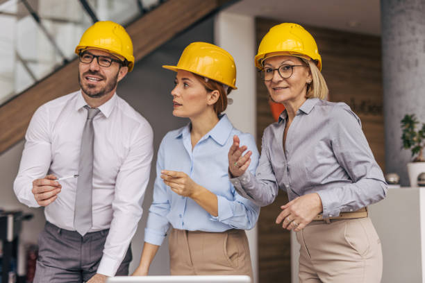 istock Architects wearing hardhats having a meeting in a modern office 2200368517