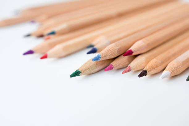 istock Colorful wooden pencils on white surface in assorted shades 2200368938