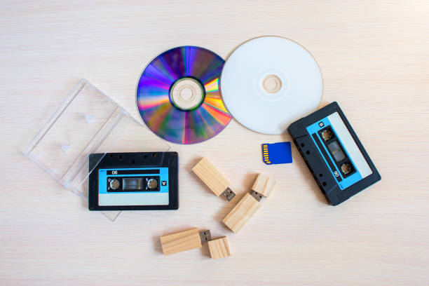 istock Old recorder cartridge, USB stick, and compact disks together 2200369122