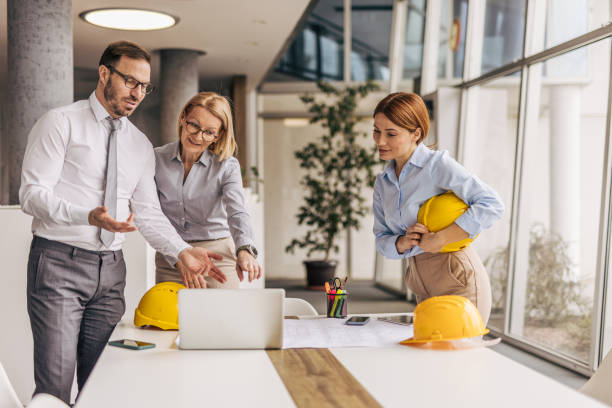 istock Architects discussing a project on a laptop in the office 2200370883