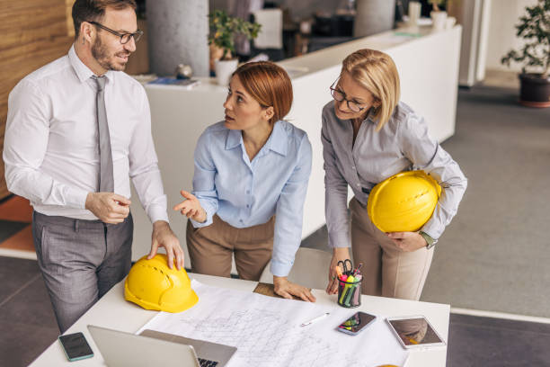 istock Architects discussing building plans in the office 2200371035