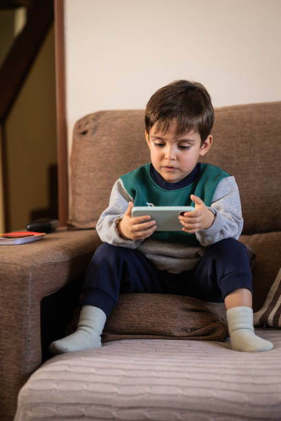 istock Small Child Holding a Smartphone, Focused on the Screen 2200371954