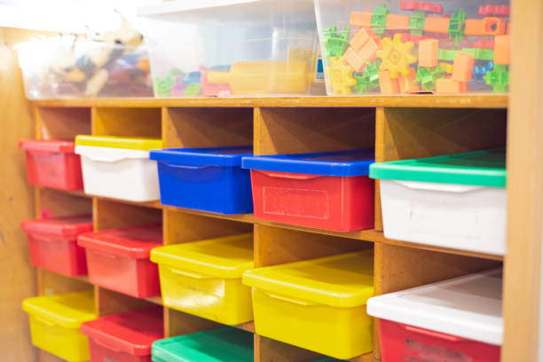 istock Kindergarten classroom organization with wooden building blocks, plastic connecting gear shapes, animal figurines in transparent boxes, row colorful storage bins with lids school supplies, Texas 2200372394