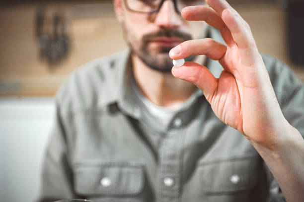 istock man in interior of kitchen taking medication 2200373168