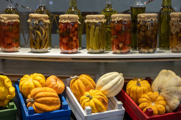 Various canned fruits and vegetables with autumn decoration