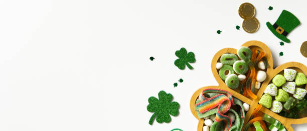 istock St. Patrick's Day shamrock tray with candies on white background 2200378671