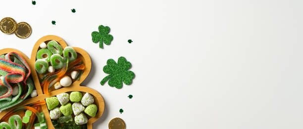 istock St. Patrick's Day shamrock tray with candies on white background 2200378893