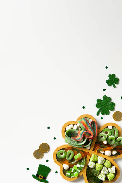 istock St. Patrick's Day shamrock shaped tray with candies on white background. Flat lay. Top view 2200379141