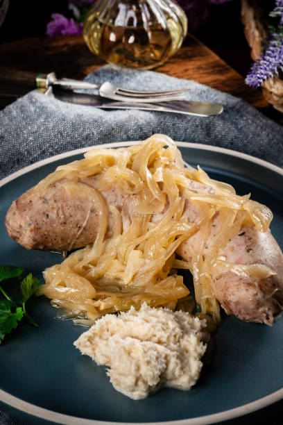 istock Fried white sausage with onions. 2200381151