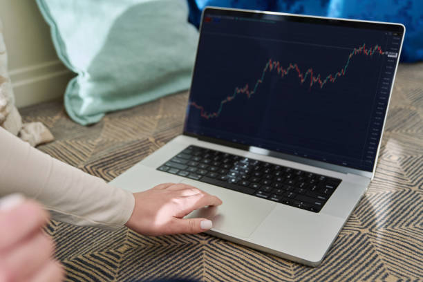 istock Laptop screen with market analysis charts, woman working on computer 2200381349