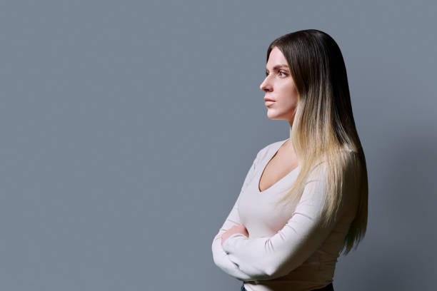 istock Young confident serious woman profile view on gray background 2200381628