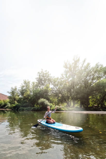 istock Woman on standup paddleboard 2200381846