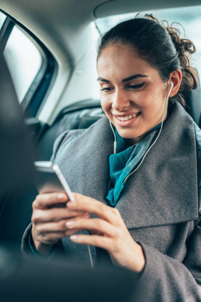 istock Business Woman Using Smartphone in Car Backseat 2200383291