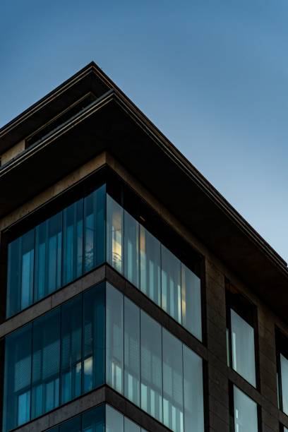 istock Modern architectural building corner with glass facade against a clear evening sky in Frankfurt 2200384402