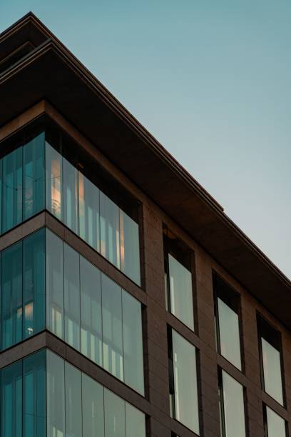 istock Modern architectural building corner with glass facade against a clear evening sky in Frankfurt 2200384407