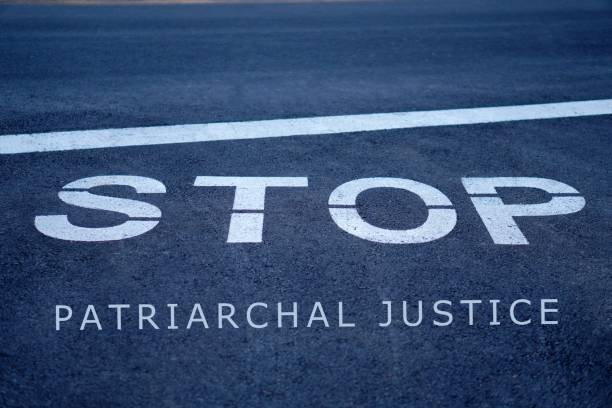 istock stop patriarchal justice. global social problem. words written on the asphalt. 2200384709