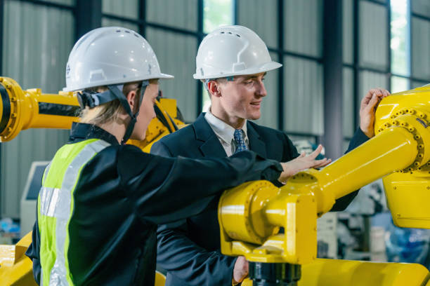 istock Engineers collaborate on robotic technology in a modern industrial facility during daytime hours 2200386455