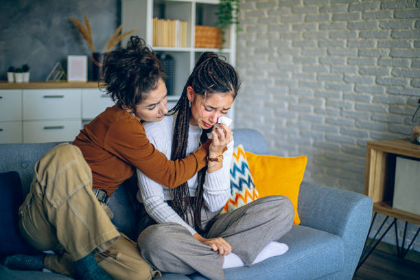 istock Stressed woman crying while her friend is comforting her 2200387442