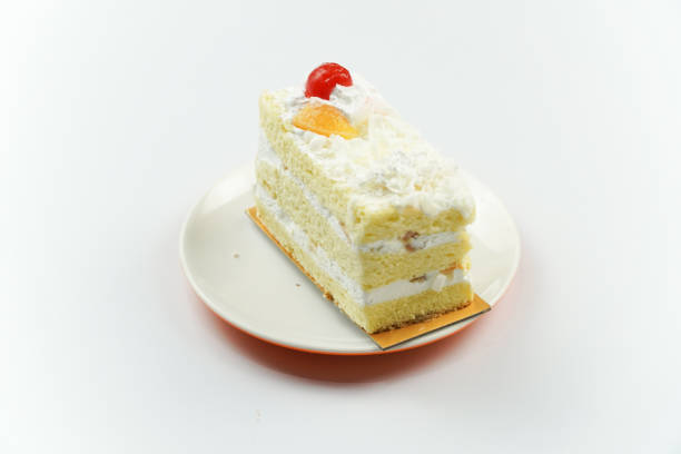 istock Slice of Yellow Cream Cake with Fruit Topping 2200388091