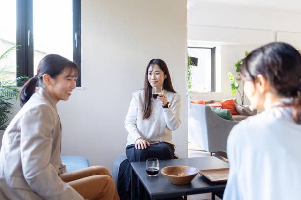 istock Female freelance workers sitting on sofa and taking a coffee break 2200389287