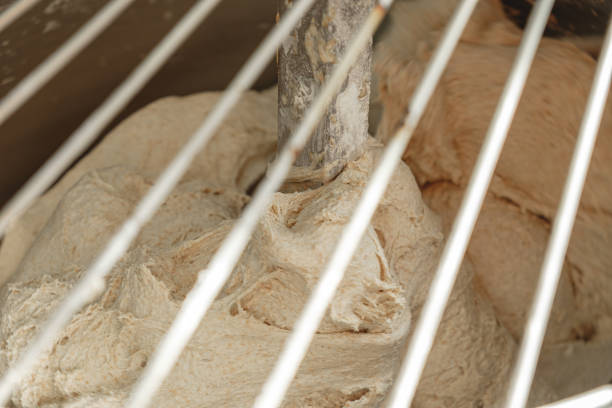 istock Kneading dough for fresh bread in a bustling bakery during the early morning hours 2200392003