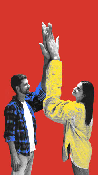 istock Man and woman raising oversized hands in synchronized high five, showing cooperation and shared agreement against red background. 2200393548
