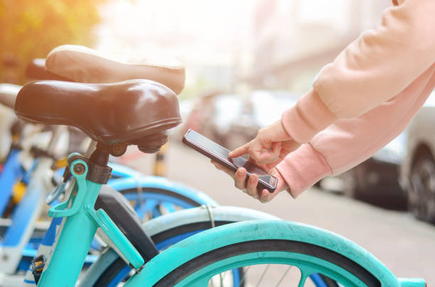 istock People use smart phone to scan the QR code on a shared bike to unlock it. 2200396146