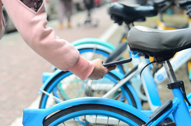 istock People use smart phone to scan the QR code on a shared bike to unlock it. 2200396155