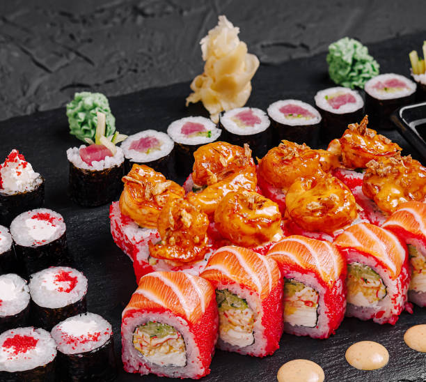 istock Delightful sushi platter featuring colorful rolls and fresh ingredients served on a dark slate board 2200397476