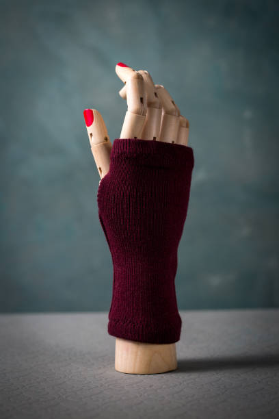 istock A mannequin hand with red nails and a maroon mitten 2200397501