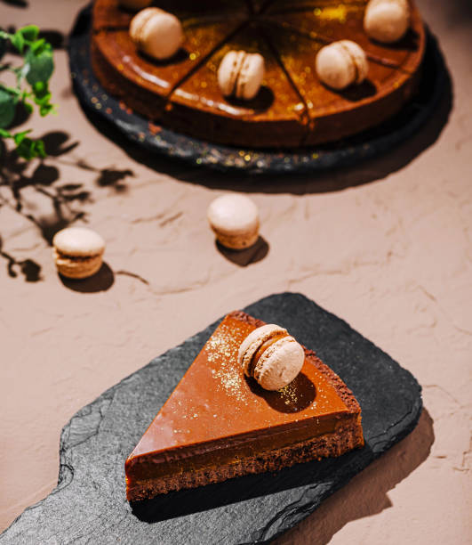 istock Delicious chocolate cake with macarons presented on a rustic surface in a cozy outdoor setting 2200397921