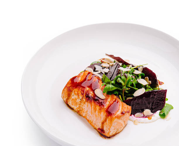 istock Deliciously plated salmon with greens and beets presented elegantly on a white dish 2200399697