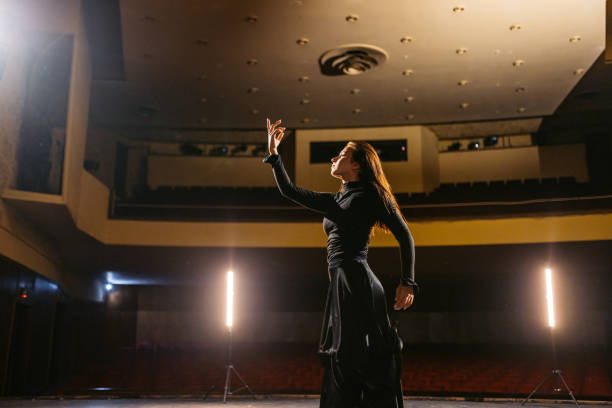 istock Young Woman Performing Interpretative Dance In An Empty Theatre 2200400644