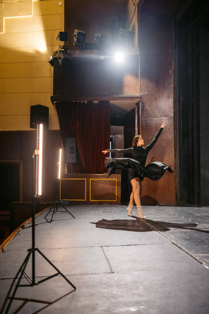 istock Young Woman Performing Interpretative Dance In A Theatre 2200400678