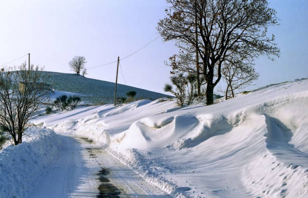 snowdrifts along a road after a blizzard