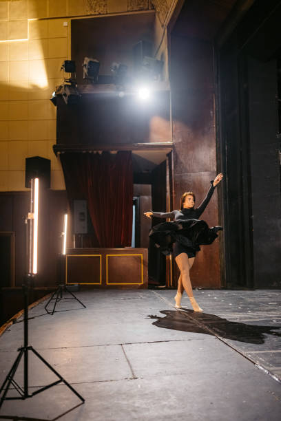 istock Young Woman Performing Interpretative Dance In A Theatre 2200401526