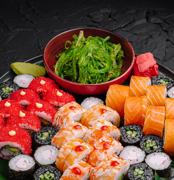 istock Delicious sushi platter featuring various rolls and sides on a dark textured surface 2200401721