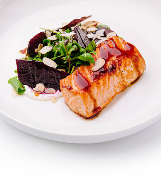 istock Deliciously plated salmon with greens and beets presented elegantly on a white dish 2200401791