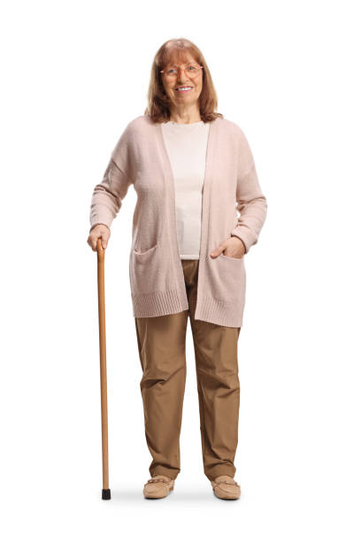 istock Mature woman standing with a walking cane 2200403315