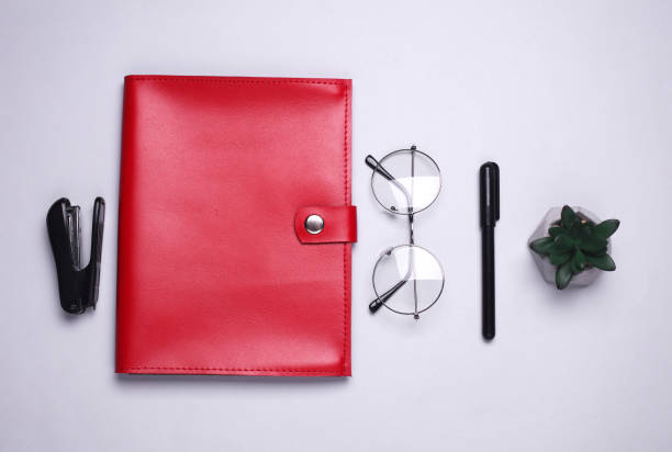 istock Organizer for important papers and documents or notebook with office supplies on white background. Flat lay 2200403755