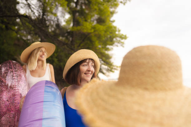 Photo of a couple of young women on their way to the local beach