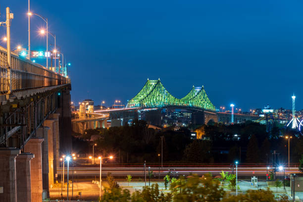 Clock Tower and Jacques Cartier bridge over St. Lawrence River in Montreal