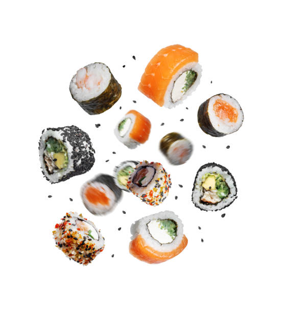 istock Various sushi rolls with sesame in the air on a white background 2200406165