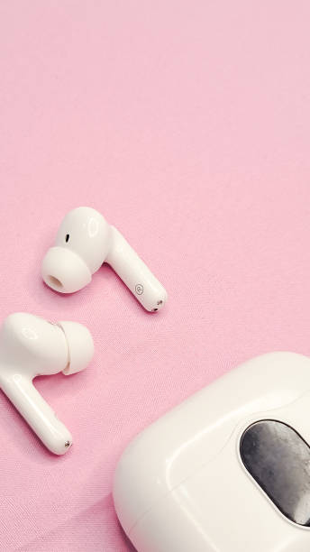 istock Modern wireless headphones on a pink background, minimalistic style. 2200409446