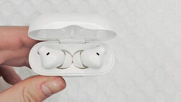 istock Modern wireless headphones on a pink background, minimalistic style. 2200409457