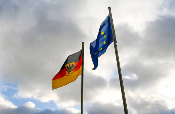 istock Flags of EU and Germany waving on flagpole in Berlin 2200412633