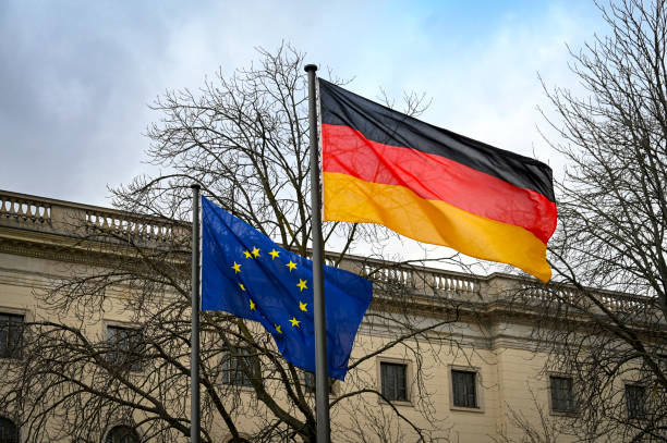 istock Flags of EU and Germany waving on flagpole in Berlin 2200412638