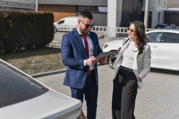 istock Joyful Friends Accidentally Meeting on Parking Lot Chatting Before Heading to Work 2200414963